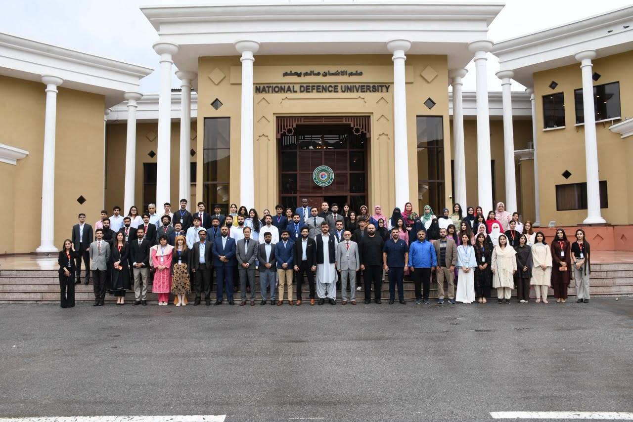 Group photograph of DAM 2026 short course participants and faculty outside National Defence University, Islamabad